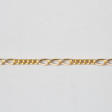 Gold chain on a light gray background