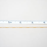 Gold chain on a white background with a ruler for scale