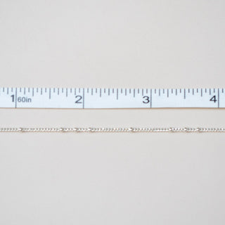 White fabric swatch with a ruler at the bottom for scale