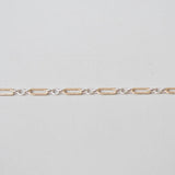 Gold chain on a light gray background