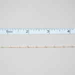 Gold chain with a ruler on a light gray background