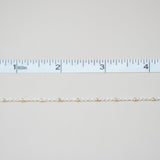Gold chain with a ruler on a light gray background