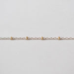 Gold chain on a light gray background