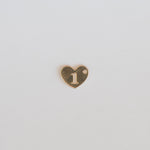 Heart-shaped charm with the number '1' on a light gray background