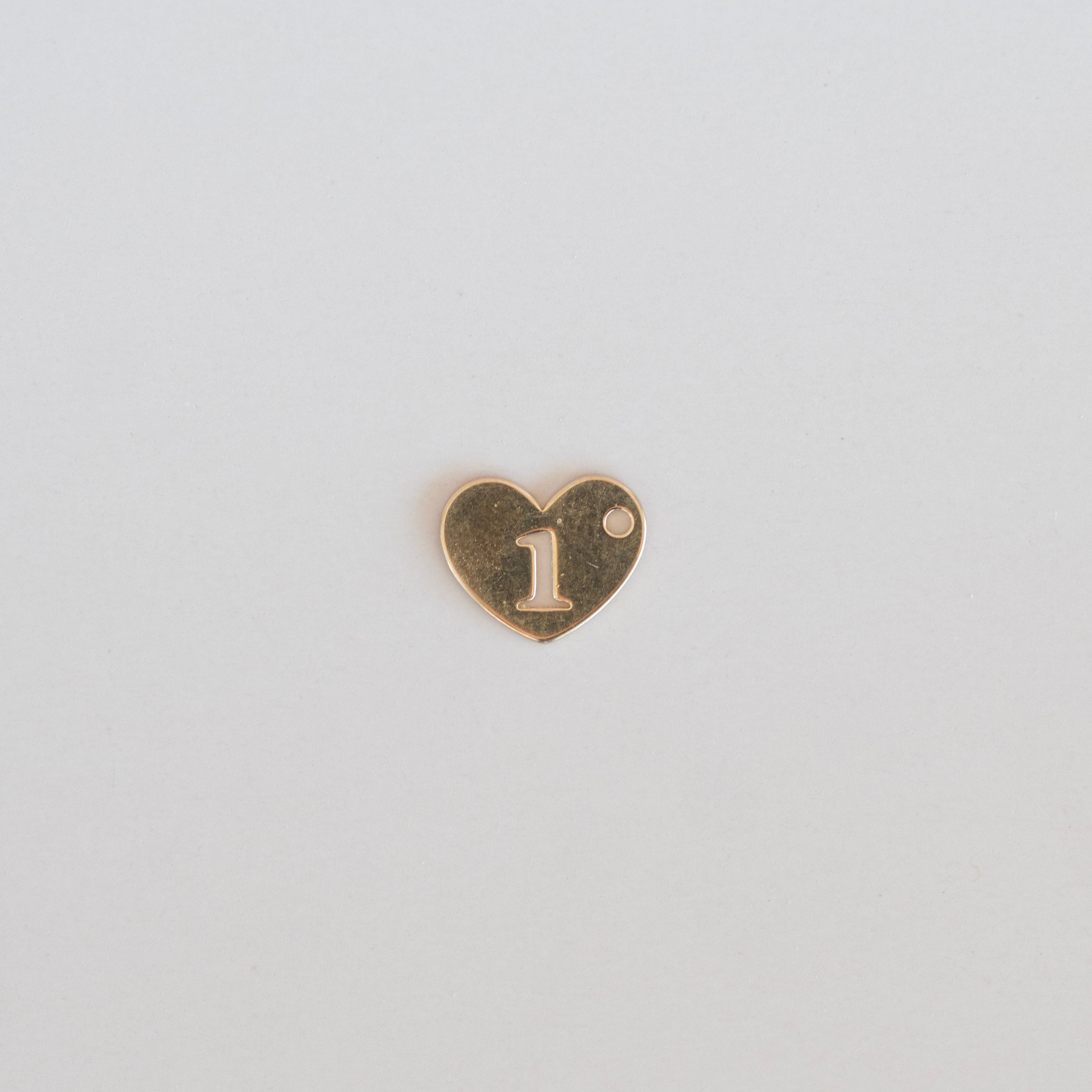 Heart-shaped charm with the number '1' on a light gray background