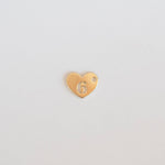 Gold heart-shaped charm with number 6 on a light gray background