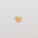 Gold heart-shaped charm with number 6 on a light gray background