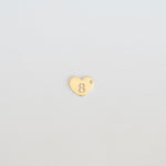 Gold heart-shaped charm with number '8' on a light gray background