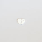 Heart-shaped logo with a white center and black outline on a light gray background