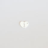 Heart-shaped logo with a white center and black outline on a light gray background