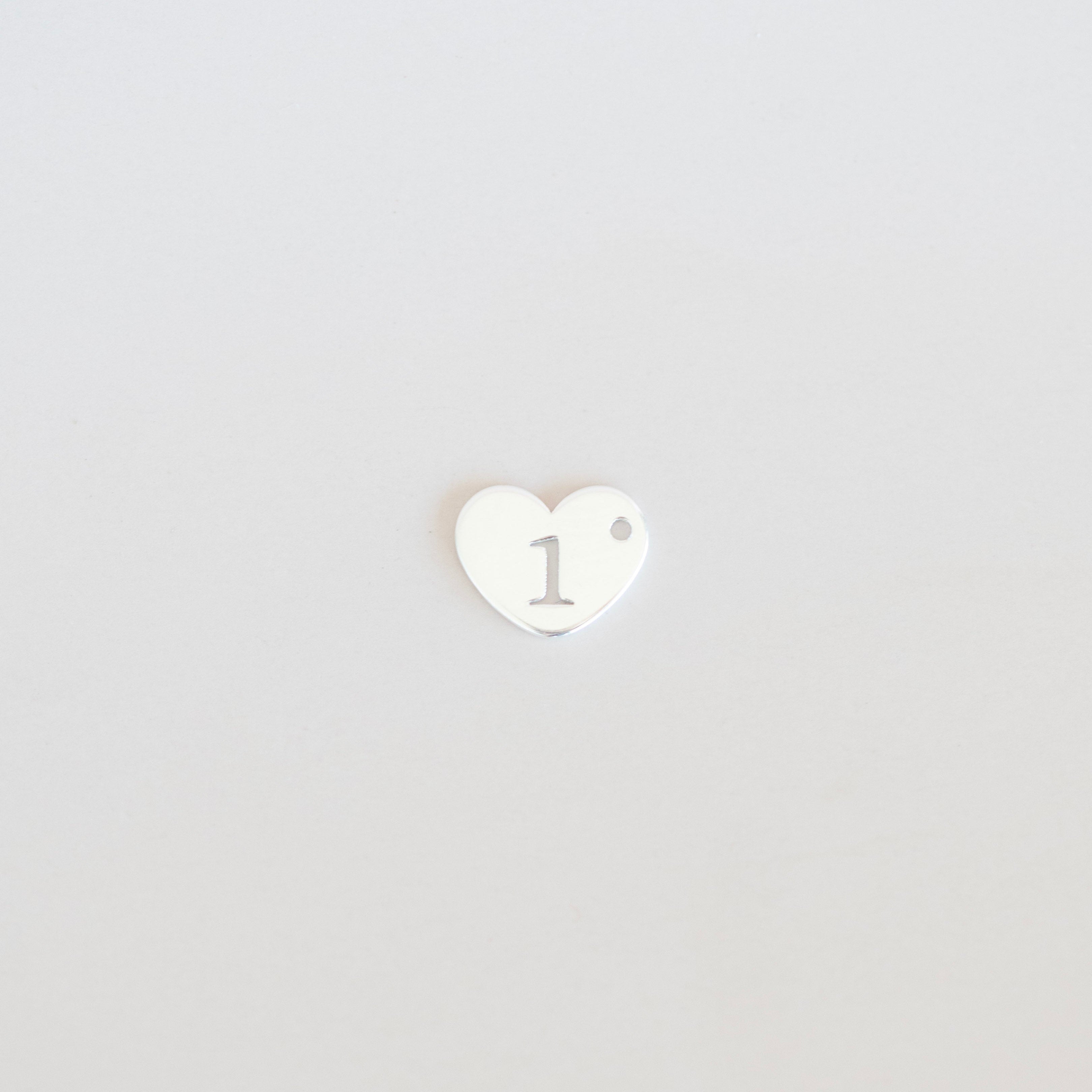 Heart-shaped logo with a white center and black outline on a light gray background