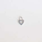 Silver heart-shaped pendant on a light gray background