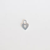 Silver heart-shaped pendant on a light gray background