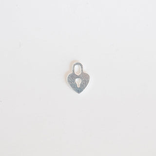 Silver heart-shaped pendant on a light gray background