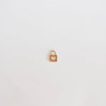 Small gold padlock on a light gray background