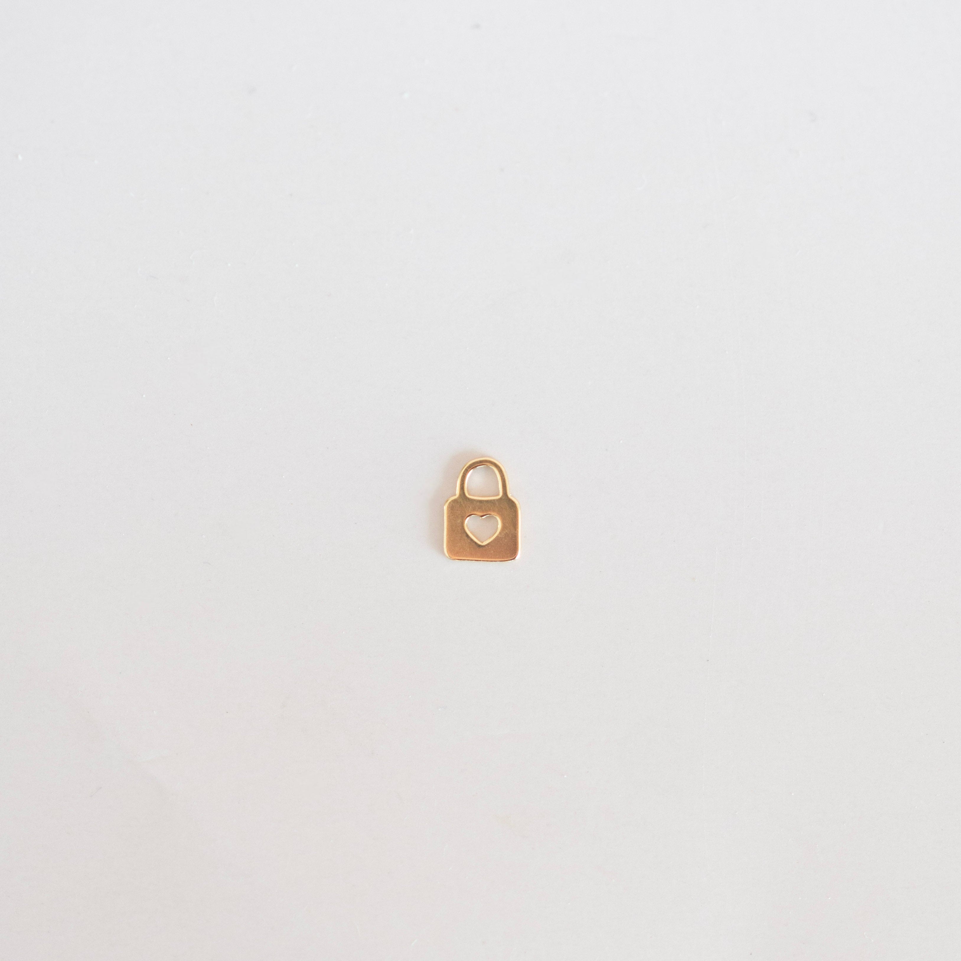 Small gold padlock on a light gray background