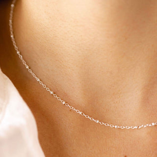 Silver necklace on a neck, E372CD72-A79A