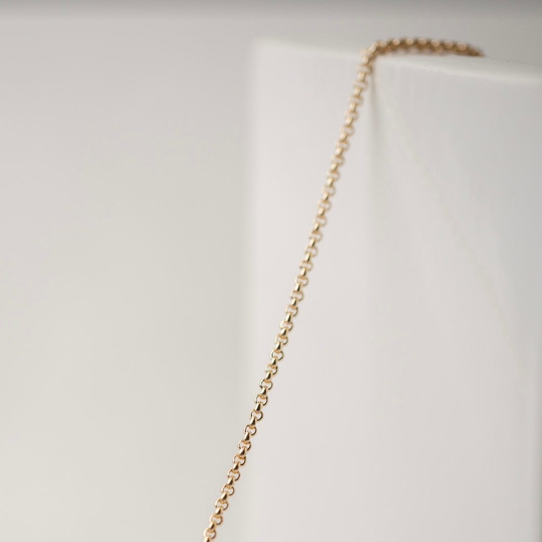 Gold chain necklace on white background