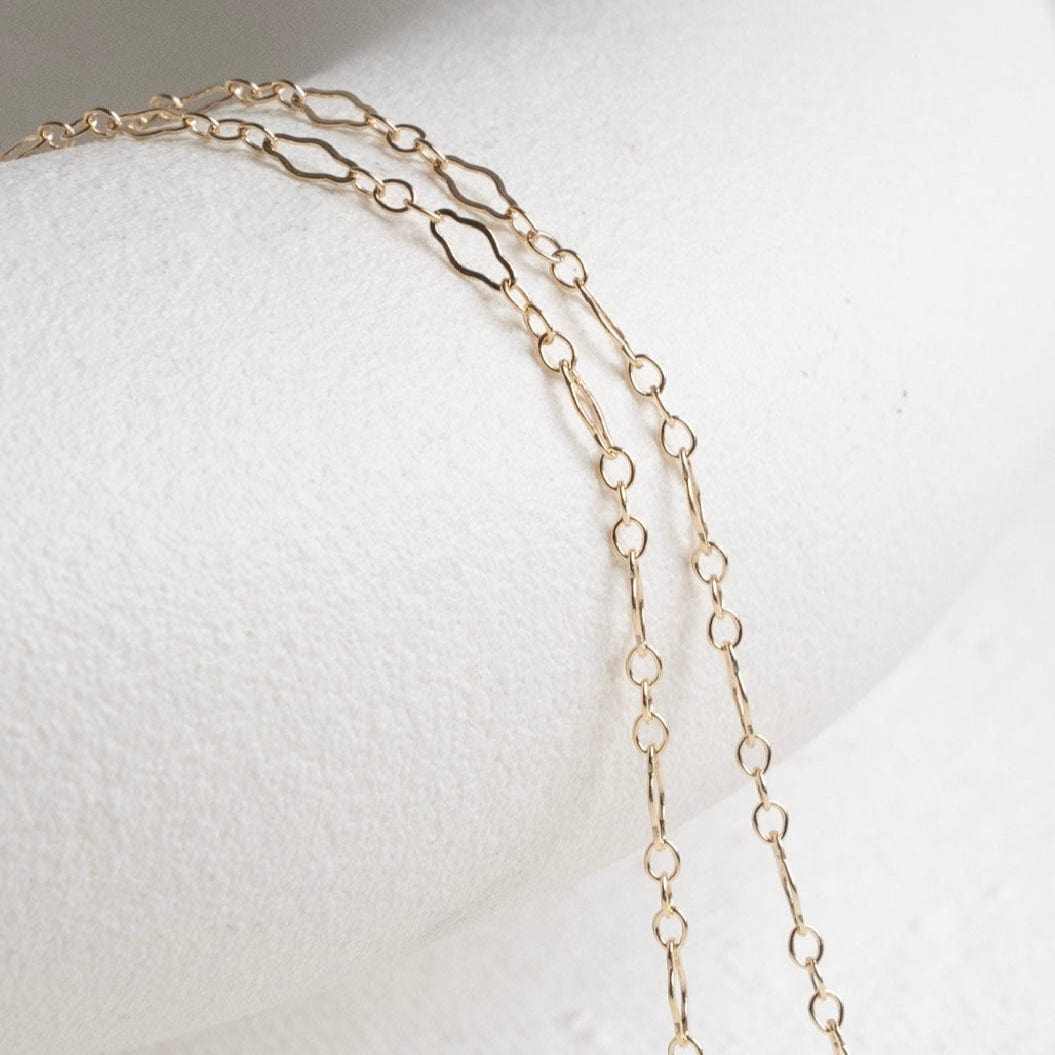 Gold chain necklace on white background