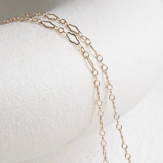 Gold chain necklace on white background