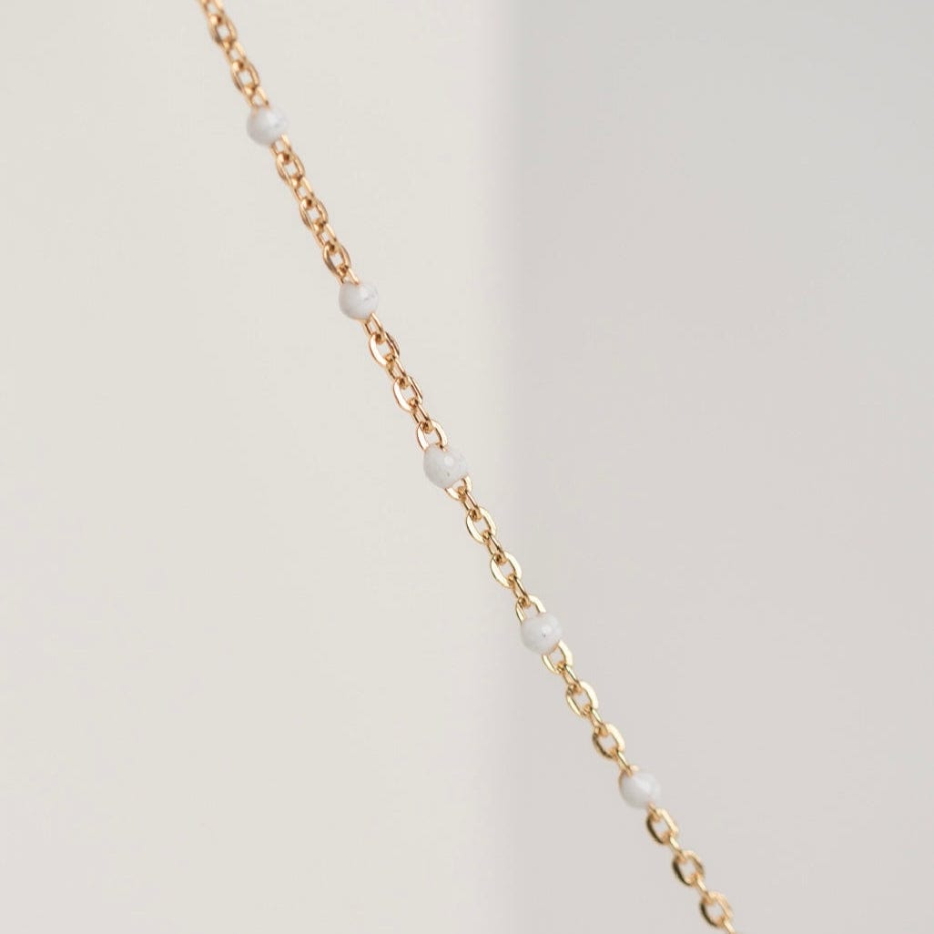 Gold chain necklace with white beads