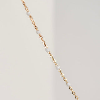 Gold chain necklace with white beads
