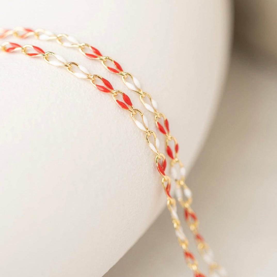 Gold chain necklace with red and white accents