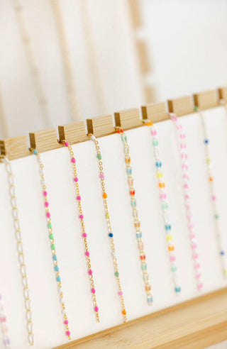 Necklaces with colorful beads on display.