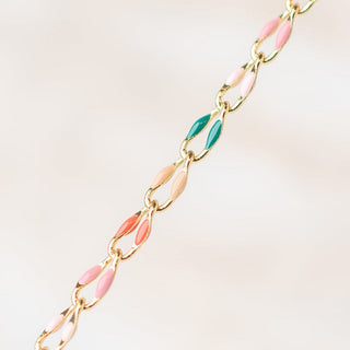 Gold chain necklace with colorful links.