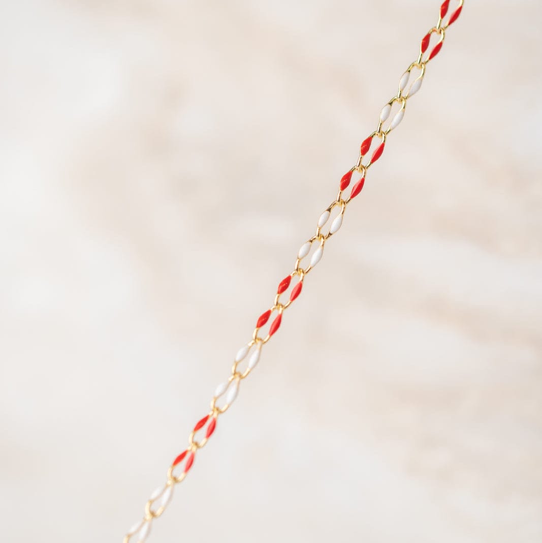 Gold chain with red and clear links.