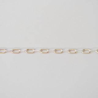 Gold chain on a light gray background
