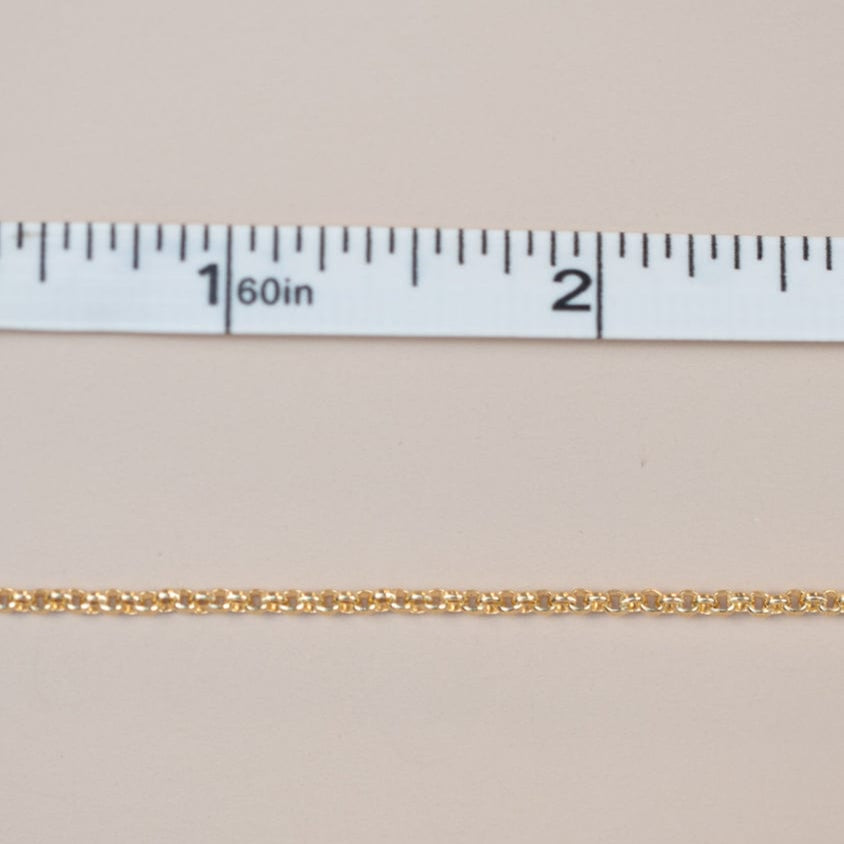 Gold chain measured with a ruler