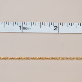 Gold chain measured with a ruler