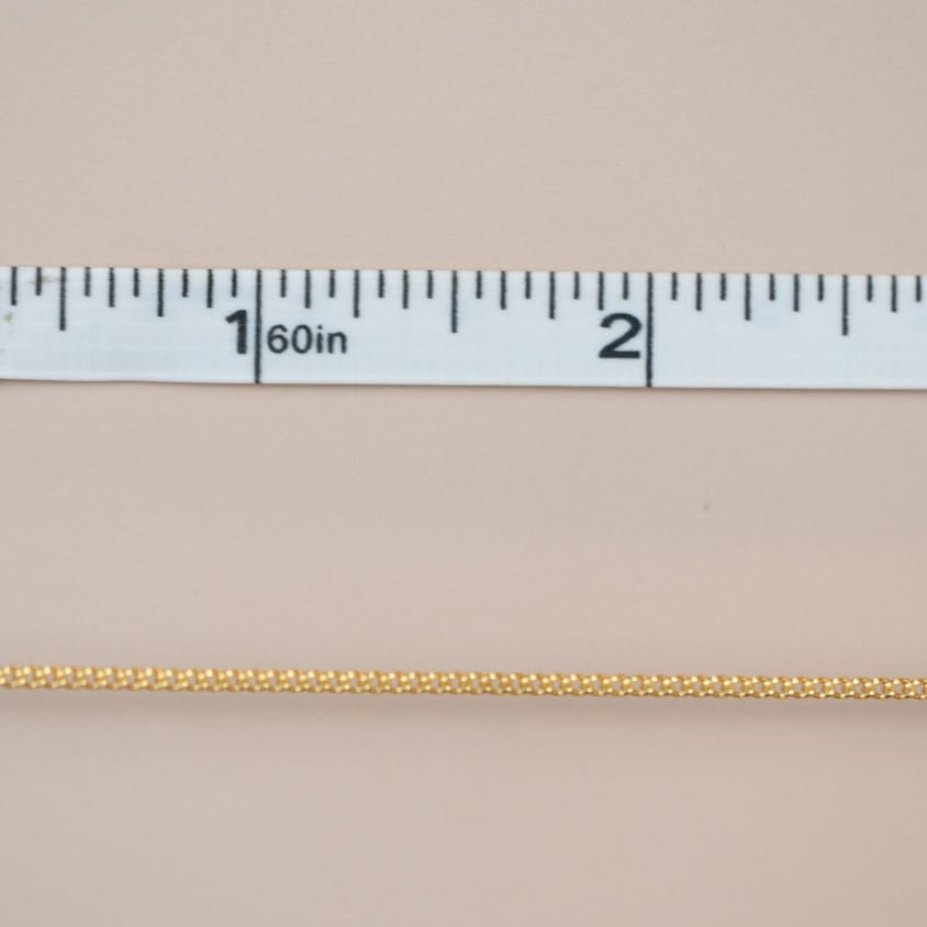 Gold chain with measurement ruler