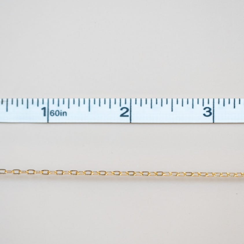 Permanent jewelry chain being measured.