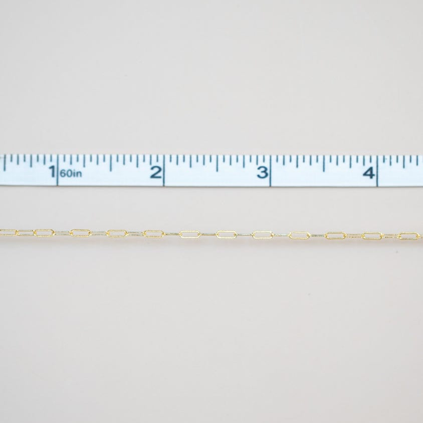 Permanent jewelry chain being measured