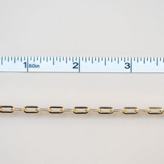 Permanent jewelry chain with ruler showing length.