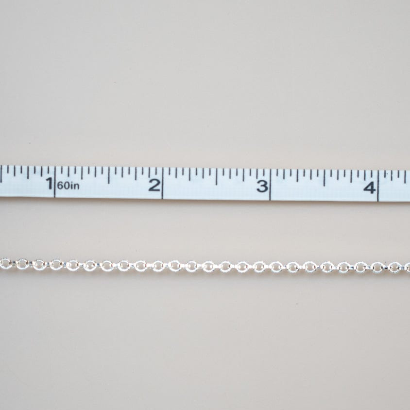Permanent jewelry chain being measured
