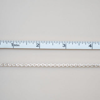 Permanent jewelry chain being measured