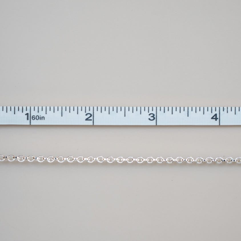Permanent jewelry chain with ruler for sizing