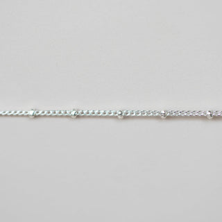 Silver chain on a light gray background