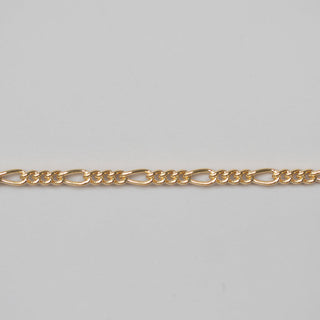 Gold chain on a light gray background