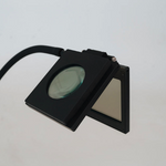 Black magnifier with light, screenshot May 14, 2025.