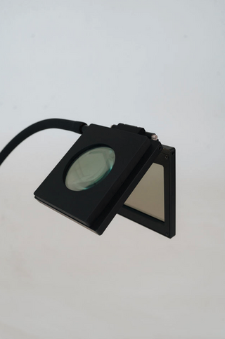 Black magnifier with light, screenshot May 14, 2025.