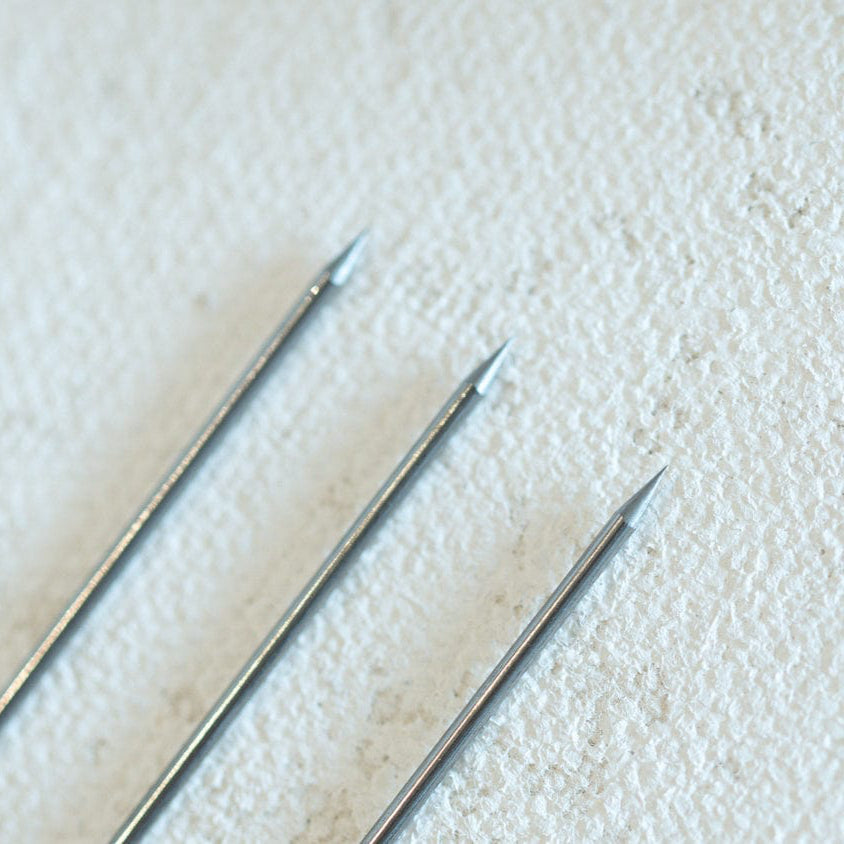 Tungsten needles close-up on white surface
