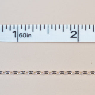 Silver chain with ruler, showing length measurement.