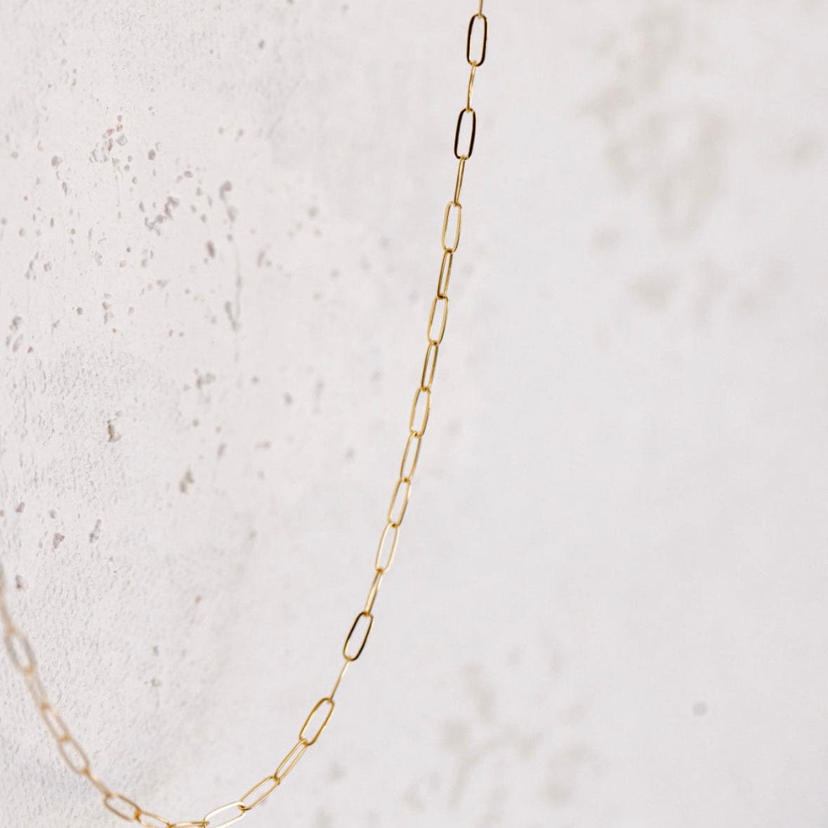 Gold chain necklace on white background