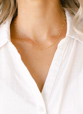 Gold chain necklace on white shirt