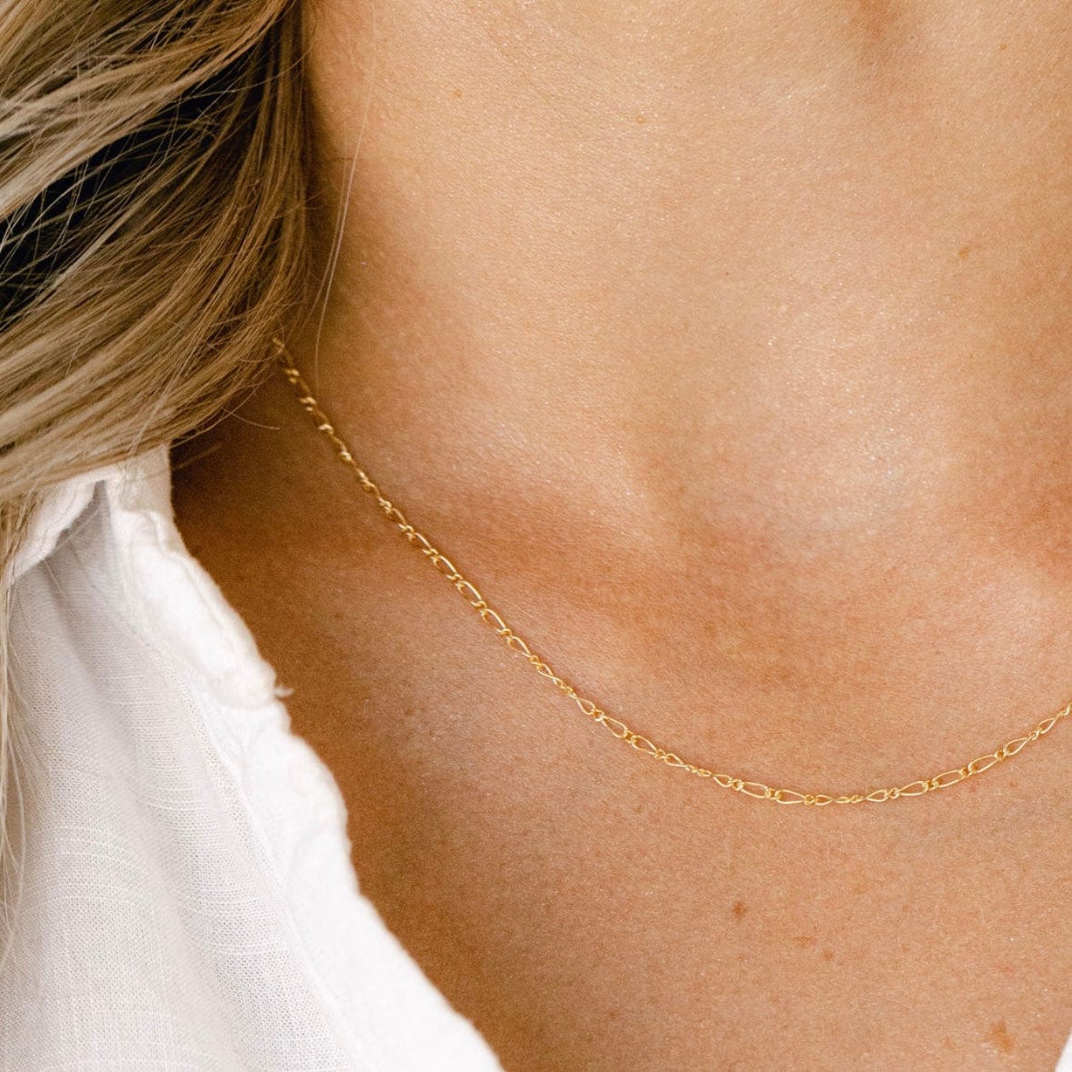 Gold chain necklace on woman