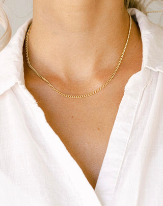 Gold chain necklace on white shirt